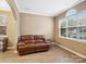 Cozy living room with a brown leather sofa and plenty of natural light at 3140 S Legacy Park Blvd, Fort Mill, SC 29707