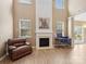 Cozy living room with a fireplace, high ceilings, and a wall of windows at 3140 S Legacy Park Blvd, Fort Mill, SC 29707