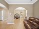 Inviting living room with brown leather sofa and arched doorway at 3140 S Legacy Park Blvd, Fort Mill, SC 29707