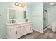 Elegant bathroom featuring double sinks, white cabinets, and a glass-enclosed shower at 400 E 1St St, Cherryville, NC 28021
