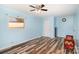 Bright bedroom featuring blue walls and hardwood floors providing a peaceful ambiance at 400 E 1St St, Cherryville, NC 28021