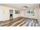 Cozy living room features wood-look floors, a ceiling fan, and views into kitchen at 400 E 1St St, Cherryville, NC 28021