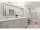 Bathroom with double sinks, grey cabinets, and marble floors at 401 Woodland St, Davidson, NC 28036