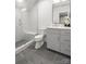 The bathroom features a glass shower with bench and modern grey vanity and fixtures at 401 Woodland St, Davidson, NC 28036