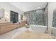 Bright bathroom featuring freestanding tub, walk-in shower, and marble floors at 401 Woodland St, Davidson, NC 28036