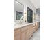 Bathroom with dual vanities, marble countertop, and decorative tile accent wall at 401 Woodland St, Davidson, NC 28036