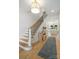 Bright and airy entryway with hardwood floors, a staircase, and a view into the kitchen at 401 Woodland St, Davidson, NC 28036