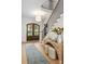 Elegant entryway featuring hardwood floors, a staircase with iron railings, and stylish decor at 401 Woodland St, Davidson, NC 28036