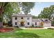 Stunning two-story home featuring a manicured lawn, double door entry, and a charming facade at 401 Woodland St, Davidson, NC 28036