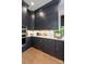 Contemporary kitchen with dark cabinets, modern appliances, and ample counter space at 401 Woodland St, Davidson, NC 28036