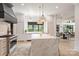 Bright and spacious kitchen featuring a marble island, stainless steel appliances, and a view to the dining area at 401 Woodland St, Davidson, NC 28036