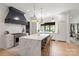 Well-lit kitchen with marble island, white cabinets, and stainless steel appliances at 401 Woodland St, Davidson, NC 28036