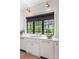 Bright kitchen area with a large window, white cabinets, and stylish backsplash at 401 Woodland St, Davidson, NC 28036