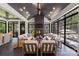Beautiful sunroom with a fireplace, ample seating, and expansive windows offering views of the lush backyard at 401 Woodland St, Davidson, NC 28036