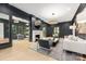 Sophisticated living room with dark walls, fireplace, modern furniture, and ample natural light at 401 Woodland St, Davidson, NC 28036