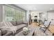 Open-concept living room with stainless steel kitchen appliances and lots of natural light at 401 Woodland St, Davidson, NC 28036