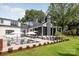 Resort-style pool area with ample seating, stylish umbrellas, and lush landscaping at 401 Woodland St, Davidson, NC 28036
