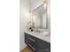 Modern powder room with vanity, quartz countertop, and pendant lighting at 401 Woodland St, Davidson, NC 28036