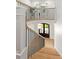 Bright staircase with wood treads, black railings, and transom door at 401 Woodland St, Davidson, NC 28036