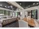 Spacious sunroom with a dining area and ample seating, offering seamless indoor-outdoor living with multiple windows at 401 Woodland St, Davidson, NC 28036