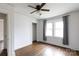 Bedroom boasts wood floors, a ceiling fan, neutral walls, and a window with curtains that provides natural light at 402 Pickens Ct, Rock Hill, SC 29730