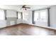 Bright living room featuring hardwood floors, fresh paint, a ceiling fan, and several windows at 402 Pickens Ct, Rock Hill, SC 29730