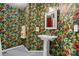 The bathroom features floral wallpaper and a white pedestal sink, giving it a vintage aesthetic at 413 19Th Avenue Ne Ct, Hickory, NC 28601