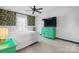 Bright bedroom featuring a ceiling fan, colorful wallpaper, and sleek furniture against white walls at 413 19Th Avenue Ne Ct, Hickory, NC 28601