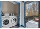 Convenient laundry room with modern washer and dryer, storage space, and deck access at 413 19Th Avenue Ne Ct, Hickory, NC 28601
