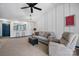 Cozy living room with plush seating, ceiling fan, wainscoting accents, and a view into the kitchen at 413 19Th Avenue Ne Ct, Hickory, NC 28601