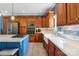 Well-lit kitchen features stainless steel appliances and ample wood cabinetry with a white farmhouse sink at 4130 Brownwood Nw Ln, Concord, NC 28027