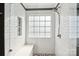 Modern shower featuring white subway tile walls, a built-in bench, and contemporary fixtures at 4130 Brownwood Nw Ln, Concord, NC 28027