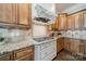 Well-lit kitchen featuring granite countertops, wooden cabinets, and stainless steel gas cooktop at 492 Agnew Rd, Mooresville, NC 28117