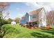Spacious backyard showcasing the home's exterior, large lawn, and a storage shed at 5601 Underwood Ave, Charlotte, NC 28213
