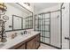 Modern bathroom featuring a white subway tile shower with a black-framed glass door at 5601 Underwood Ave, Charlotte, NC 28213