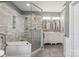 Elegant bathroom with a tiled shower, dual sinks, and sleek modern fixtures offers a luxurious experience at 5601 Underwood Ave, Charlotte, NC 28213