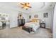 Bedroom with tray ceilings, a king bed, a leather trunk and a ceiling fan at 5601 Underwood Ave, Charlotte, NC 28213