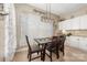 Charming dining area with a modern chandelier, decorative curtains, and convenient access to the kitchen at 5601 Underwood Ave, Charlotte, NC 28213
