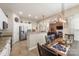 Dining area with a wooden table, chandelier lighting, and an open view to the kitchen and living room at 5601 Underwood Ave, Charlotte, NC 28213