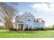 Beautiful two-story home with a well-maintained lawn, mature trees, and a classic architectural style at 5601 Underwood Ave, Charlotte, NC 28213
