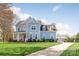 Charming two-story home featuring a welcoming porch, manicured lawn, and beautiful landscaping at 5601 Underwood Ave, Charlotte, NC 28213