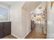 Bright hallway featuring hardwood floors and a view into the living area at 5601 Underwood Ave, Charlotte, NC 28213