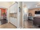 Hallway featuring built-in cabinets with granite counters, leading to the living room with fireplace at 5601 Underwood Ave, Charlotte, NC 28213