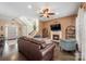 Cozy living room with a fireplace, dark wood floors, and a staircase leading to the upper level at 5601 Underwood Ave, Charlotte, NC 28213