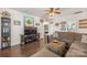 Inviting living room with a comfortable brown sectional, wood floors, and stylish decor at 5601 Underwood Ave, Charlotte, NC 28213