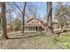 A spacious backyard featuring mature trees and a cozy screened-in porch at 6500 Windyrush Rd, Charlotte, NC 28226