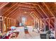 An unfinished attic space revealing exposed wooden beams, with a window at the far end of the room at 655 Mock Mill Rd, Statesville, NC 28677