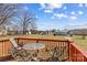 Back deck furnished with a glass table and chairs, offering a view of the expansive backyard at 655 Mock Mill Rd, Statesville, NC 28677