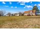 Expansive backyard offering ample space and a glimpse of the house, featuring a deck area at 655 Mock Mill Rd, Statesville, NC 28677