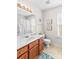 Bathroom has single sink vanity, standard toilet, large mirror, and shower with curtain at 655 Mock Mill Rd, Statesville, NC 28677